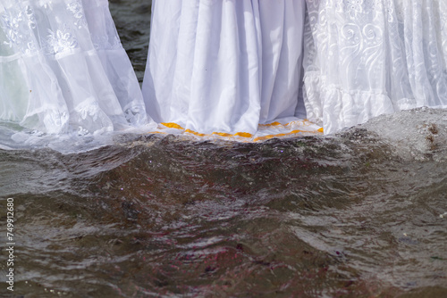 Candomble people are seen entering the sea water to honor iemanja during a party on Rio Vermelho beach. Salvador, Bahia. photo