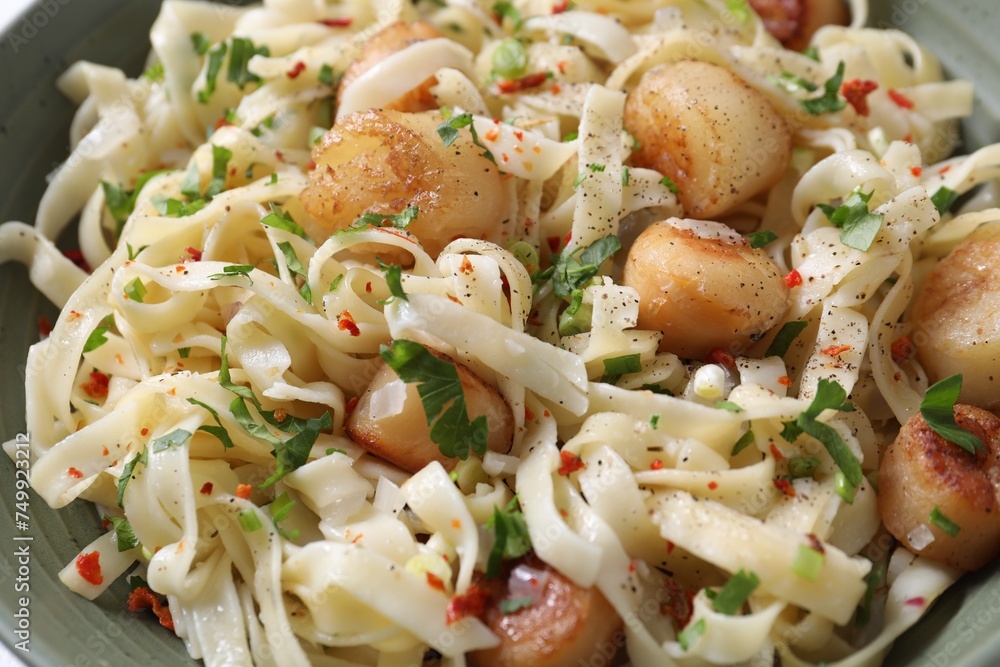 Delicious scallop pasta with spices in bowl, closeup Delicious scallop pasta with spices in bowl, closeup