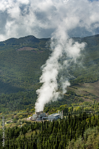 Vapor coming out of the chimney of thermal power plant, Tuscany, Italy, Europe, EU. Environmental and eco theme