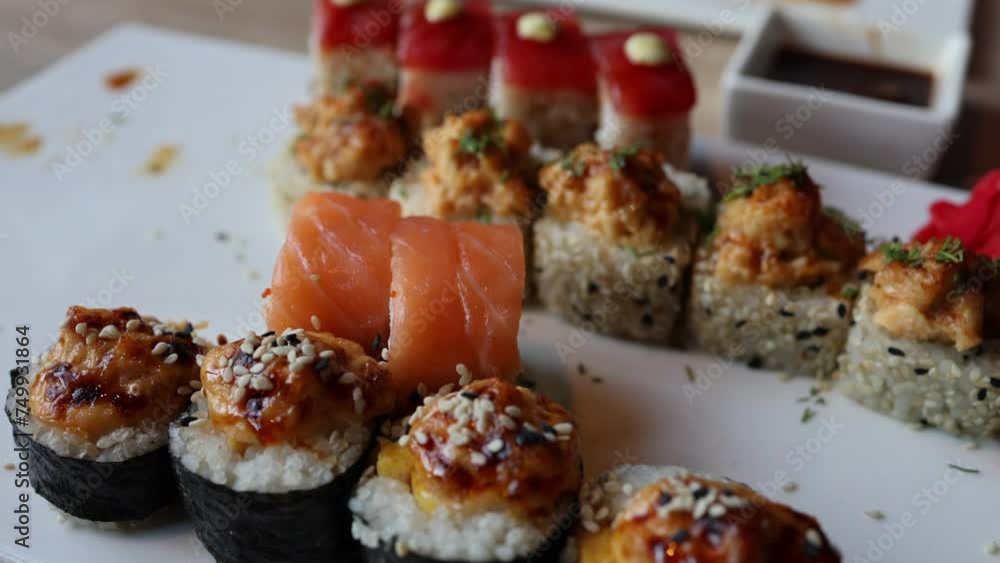 The video an assortment of Japanese sushi rolls, showcasing the exquisite combination of fresh fish and rice. The vibrant and meticulously crafted rolls reflect the artistry of Japanese cuisine. The video an assortment of Japanese sushi rolls, showcasing the exquisite combination of fresh fish and rice. The vibrant and meticulously crafted rolls reflect the artistry of Japanese cuisine.