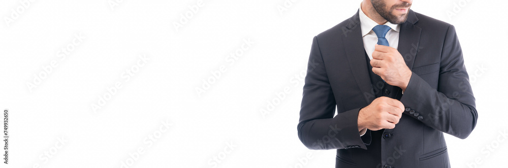 Cropped image of a professional businessman adjusting his tie, focusing on successful corporate appearance and etiquette.
