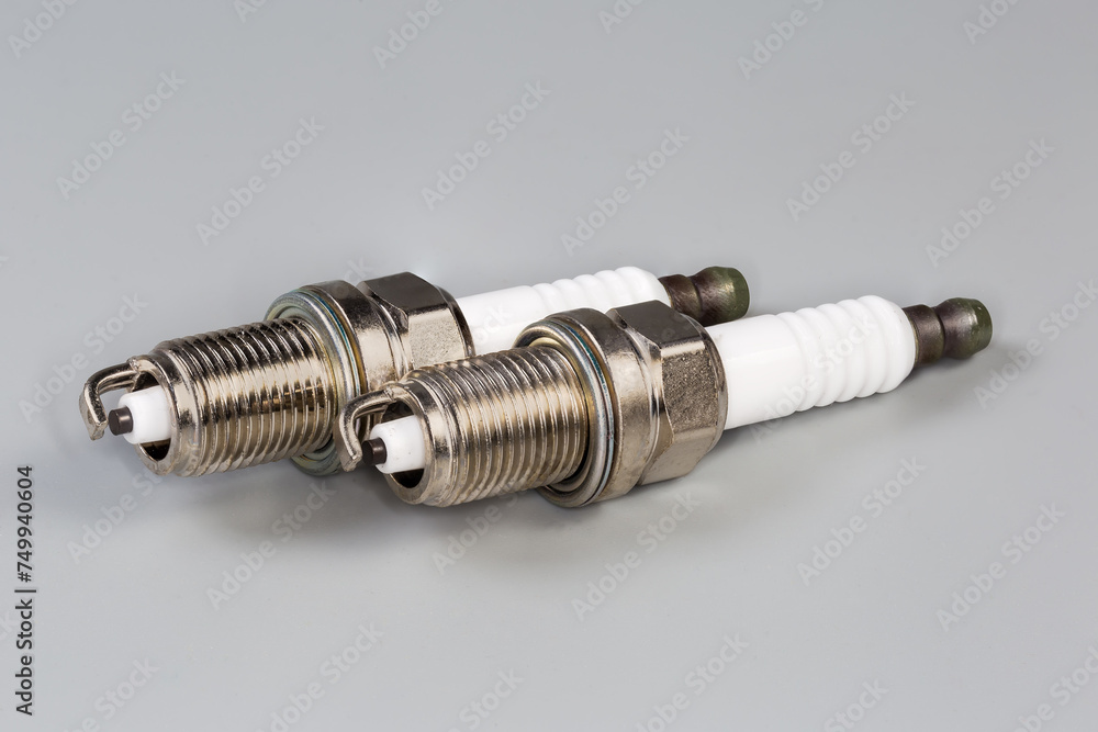 Spark plugs for petrol internal combustion engine on gray background Spark plugs for petrol internal combustion engine on gray background