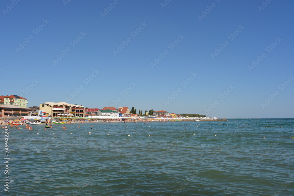 Blue sky and waves of the Black Sea, recreation and entertainment with beach musicians.