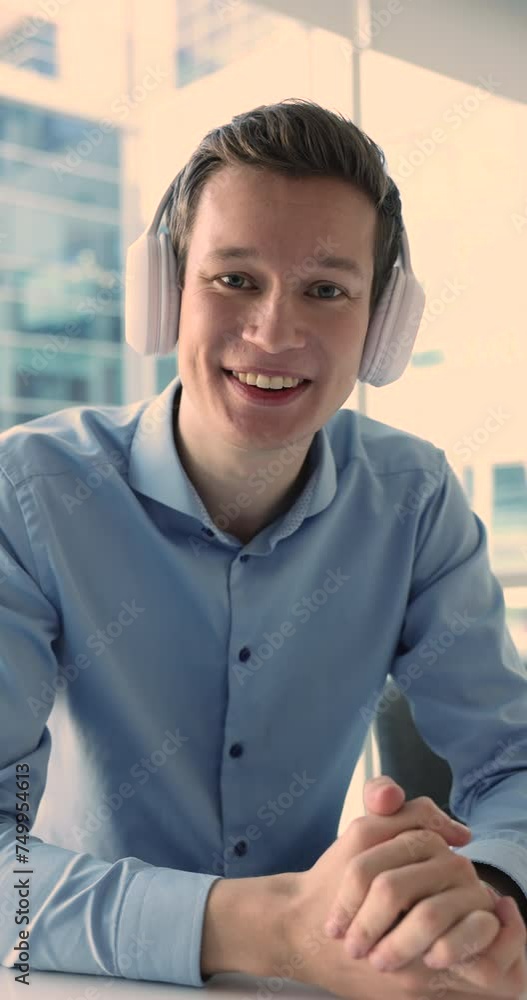 Man in wireless headphones make video conference call by business sit at desk staring at camera, lead formal communication by webcam, talking to client, consulting online. Influence, social media icon Man in wireless headphones make video conference call by business sit at desk staring at camera, lead formal communication by webcam, talking to client, consulting online. Influence, social media icon