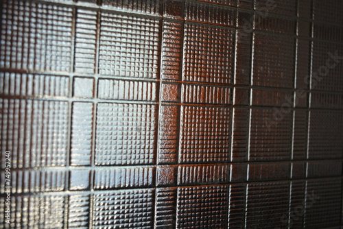 Glass dented background in the form of square wafers, squares and direct reliefs