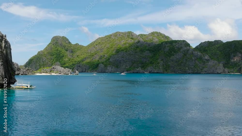 Boats over the sea near in Tapiutan Island. Blue sky and clouds. El Nido, Palawan. Philippines.