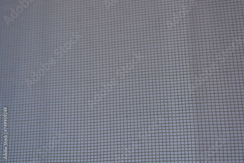 White small mosquito net against flies on a white metaloplastic window