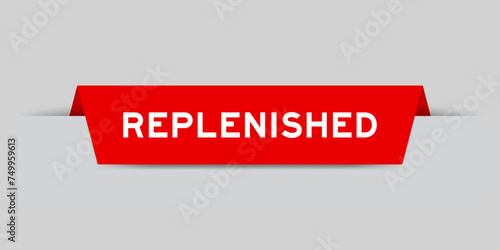Red color inserted label with word replenished on gray background