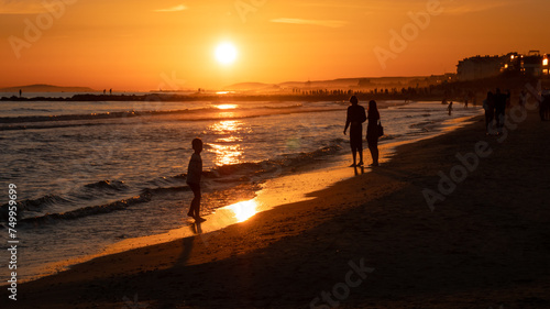 People enjoying the beach at sunset at Palavas les Flots, near Montpellier, France