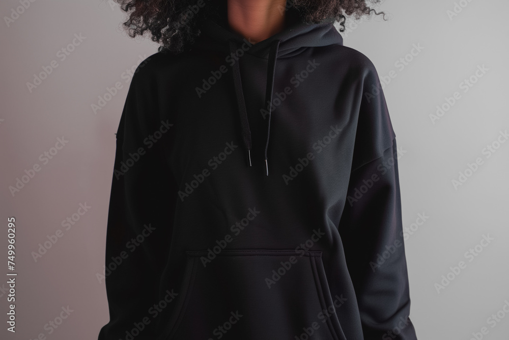 A black hoodie on a simple, solid background. Hoodie mockup. Ghost mannequin