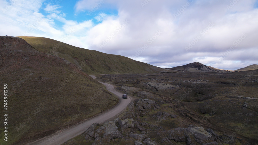 Car driving off-road terrain exploring the Fjallabak Natural Reserve. A 4x4 car driving dirt road traveling in Iceland sightseeing wilderness.