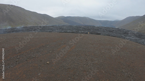 Obraz na płótnie View of cracked lava crust or ingenious rock and steam cooled down from the 2021 eruption of Fagradalsfjall volcano in Geldingadalir Valley on Reykjanes Peninsula in Iceland. w salonie