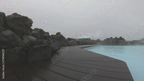 Obraz na płótnie The Blue Lagoon geothermal spa Iceland, in a lava field near Grindavík on Reykjanes Peninsula. Water's milky blue shade is due to its high silica content. Woman relaxes and enjoy of spa in hot spring. w salonie