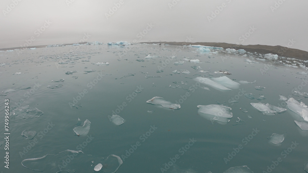View from a boat of Jokulsarlon Glacier Lagoon in Iceland. Melting icebergs floating.