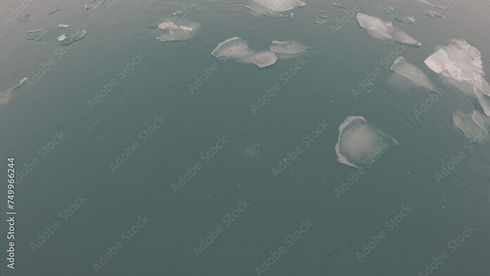 View from a boat of Jokulsarlon Glacier Lagoon in Iceland. Melting icebergs floating.