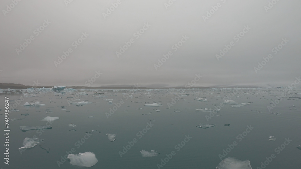 View from a boat of Jokulsarlon Glacier Lagoon in Iceland. Melting icebergs floating.