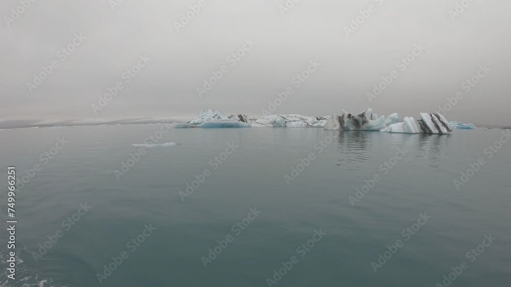 View from a boat of Jokulsarlon Glacier Lagoon in Iceland. Melting icebergs floating.