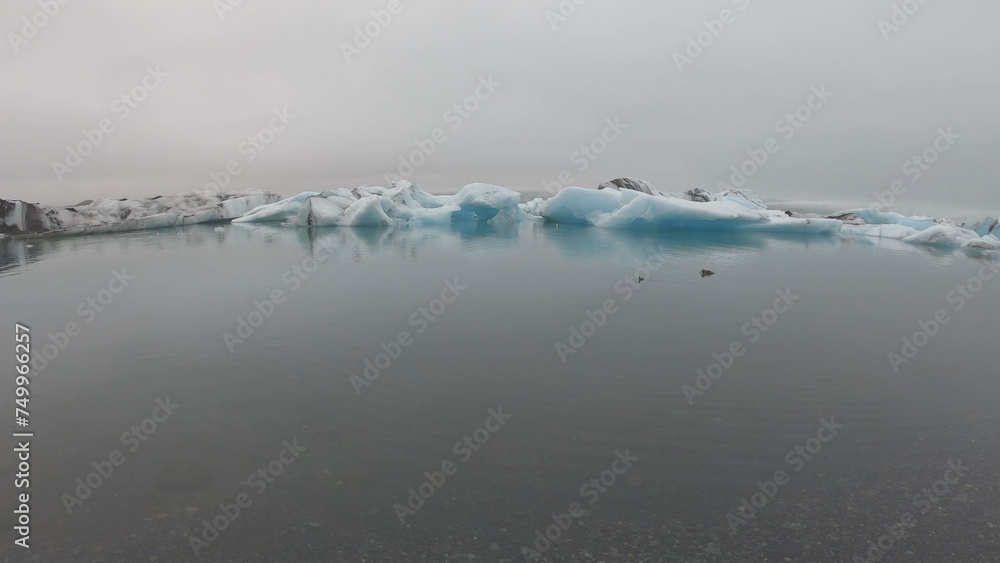 View from a boat of Jokulsarlon Glacier Lagoon in Iceland. Melting icebergs floating.