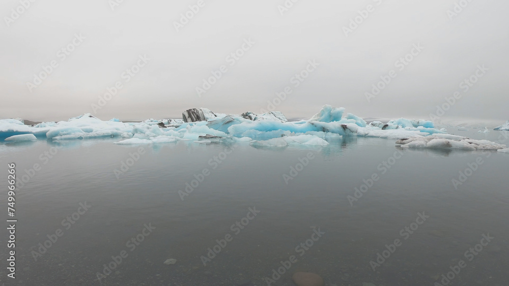 View from a boat of Jokulsarlon Glacier Lagoon in Iceland. Melting icebergs floating.