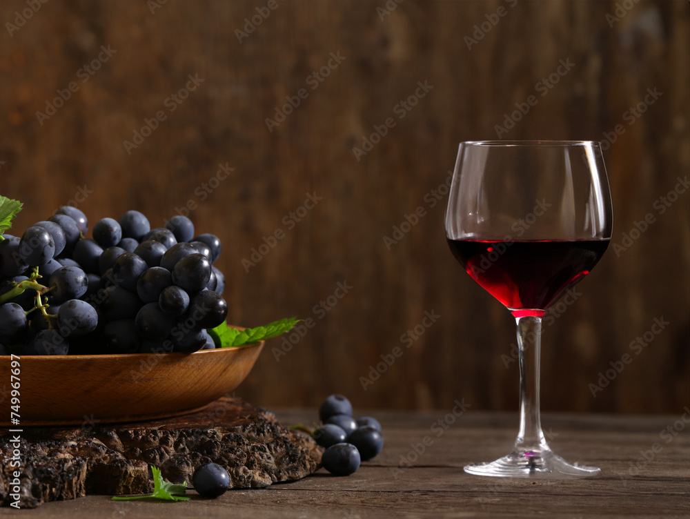 fresh grapes and red wine in a glass