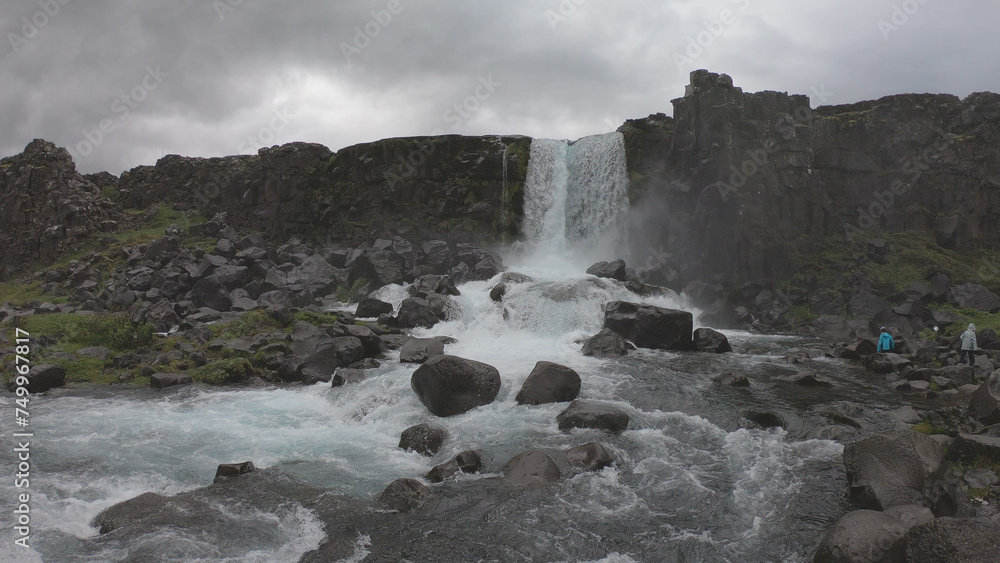 Oxararfoss is a waterfall situated within Þingvellir National Park in Southwest Iceland. The waterfall flows out the river Oxará, cascading in two drops over the cliffs of Almannagjá gorge.