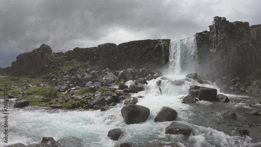 Oxararfoss is a waterfall situated within Þingvellir National Park in Southwest Iceland. The waterfall flows out the river Oxará, cascading in two drops over the cliffs of Almannagjá gorge.