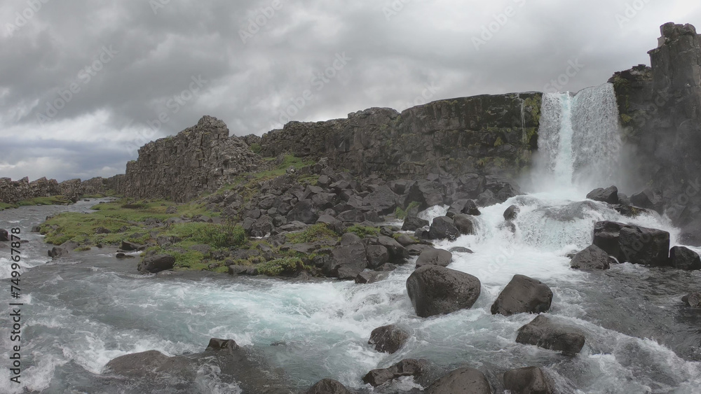 Oxararfoss is a waterfall situated within Þingvellir National Park in Southwest Iceland. The waterfall flows out the river Oxará, cascading in two drops over the cliffs of Almannagjá gorge.