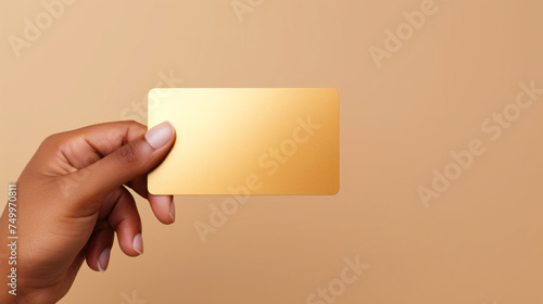 Exquisite closeup showing a manicured hand and a sleek gold ring holding an elite card plain minimalist background photo