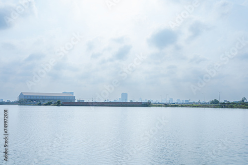 Cityscape by the River A scenic view featuring water, sky, boats, bridges, and the vibrant beauty of nature along the coast, capturing the essence of a summer day photo