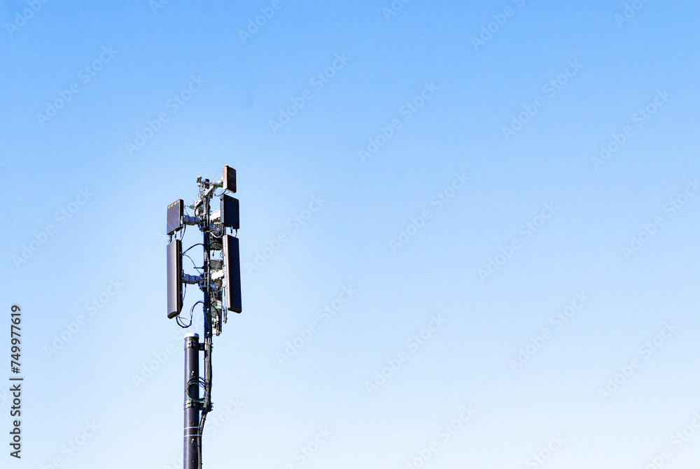 Communication tower telephone pole wireless technology signal future with electric wire tangle. Telecommunication tower of 4G and 5G cellular. Group box Antenna mounted. Sunlight cloud sky background Communication tower telephone pole wireless technology signal future with electric wire tangle. Telecommunication tower of 4G and 5G cellular. Group box Antenna mounted. Sunlight cloud sky background
