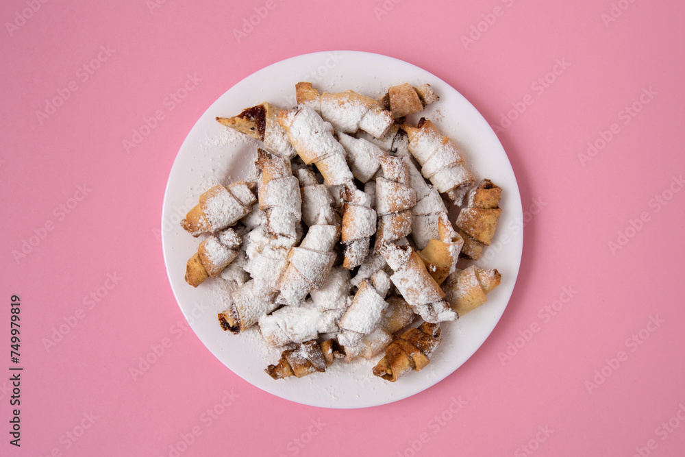 Homemade Vitushki Cookies on a Round Plate with Pink Background with Copy Space Homemade Vitushki Cookies on a Round Plate with Pink Background with Copy Space