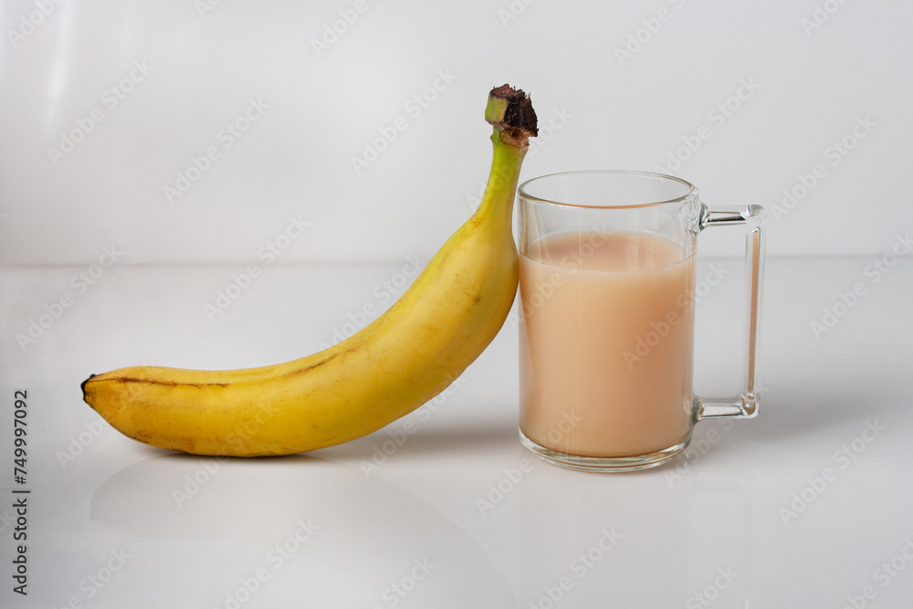 one glass of banana juice on a white glass