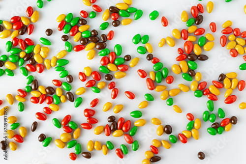 seeds in colored chocolate glaze are randomly scattered on a white background