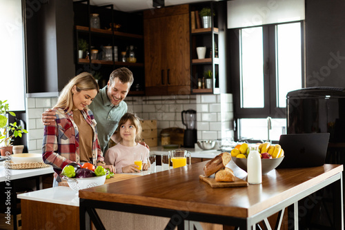 Family bonding during breakfast in a sunlit modern kitchen