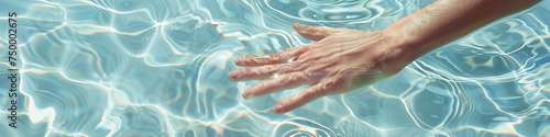 Human hand touching calm water  creating ripples
