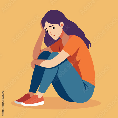 A pensive women sits with her head on her knees. is sad alone