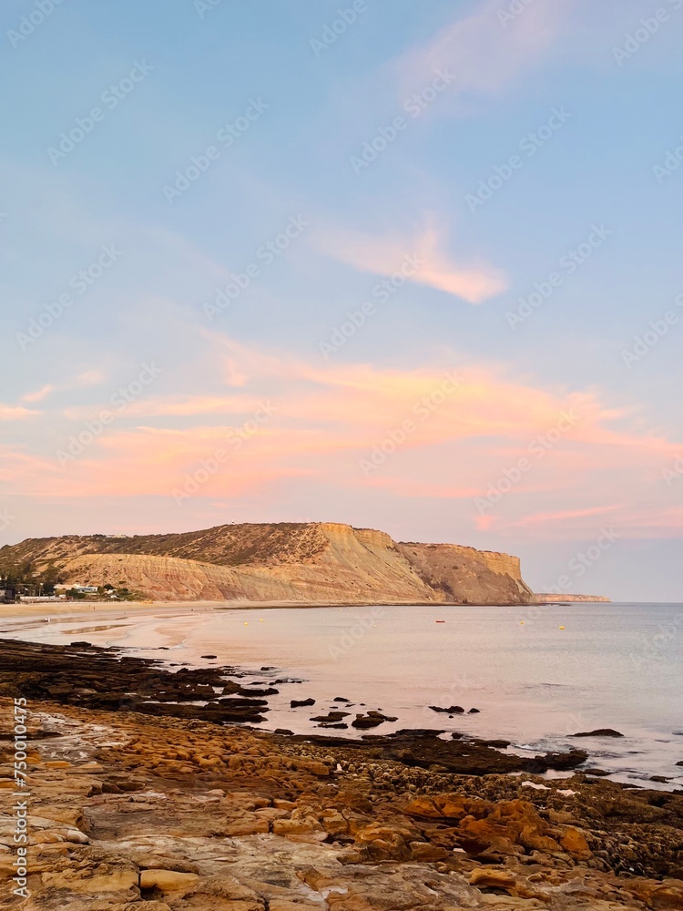 Natural pastel colors of the sky at the ocean, rocky ocean bay, purple heaven Natural pastel colors of the sky at the ocean, rocky ocean bay, purple heaven