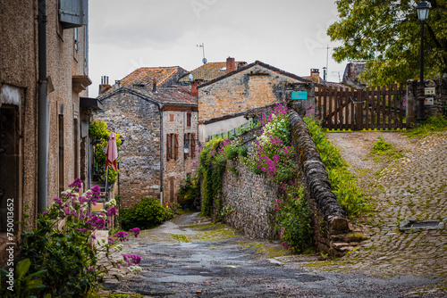 Old cobblestone medieval road in the town, the village of Cordes-Sur-Ciel in France photo