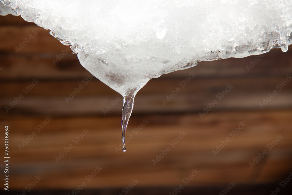 A small icicle hanging from the roof. A small icicle hanging from the roof.