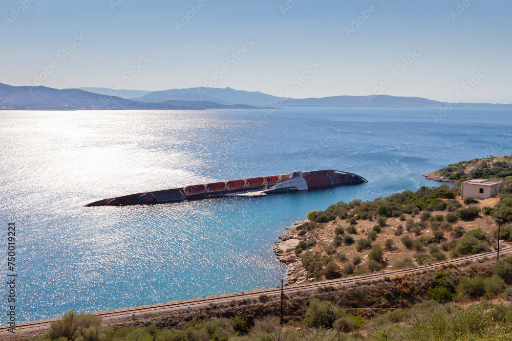 Beautiful landscape at Attica region viewing the bay of Salamina island and the shipwreck of a capsized ship, sank in the shallows in the early 2000's.