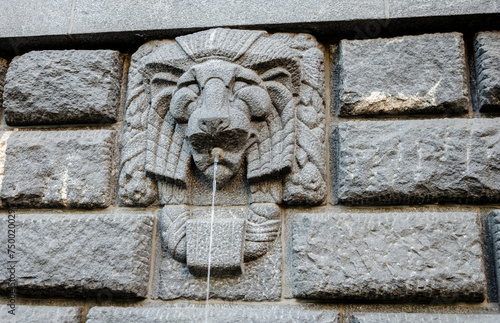 An ancient fountain in the stone wall of the building. © Сергей Лаврищев