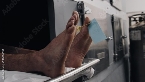 Feet in morgue cooler close up side profile photo