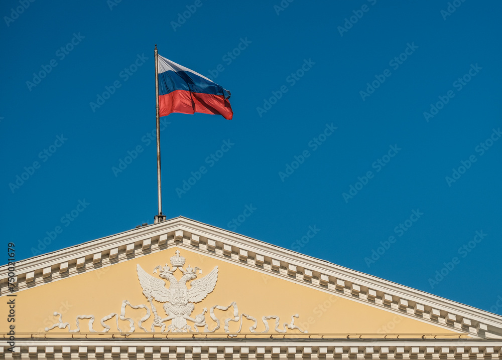 The Russian flag on the roof of an ancient building.