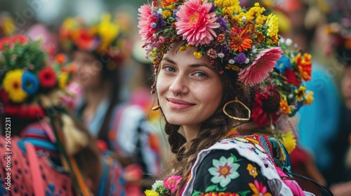 A woman adorned with a vibrant floral wreath smiles joyfully during a traditional spring equinox celebration..