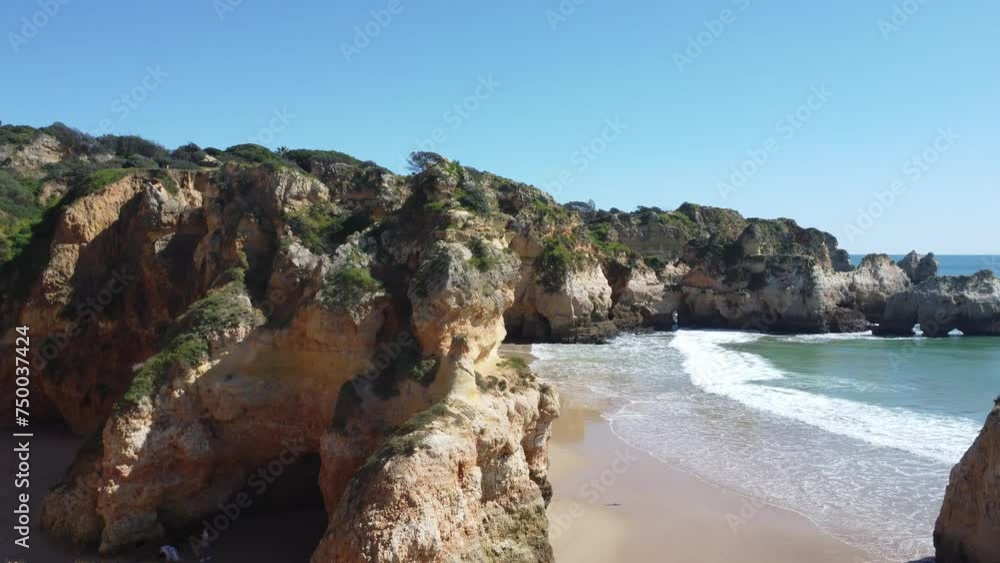 Sweeping aerial view of Alvor's pristine beach, surrounded by dramatic cliffs and azure waters, showcasing Algarve's natural beauty. Sweeping aerial view of Alvor's pristine beach, surrounded by dramatic cliffs and azure waters, showcasing Algarve's natural beauty.