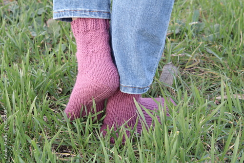 A person's legs in a grassy area