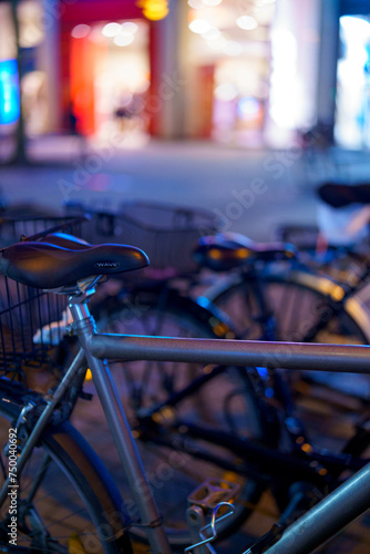 Bicycles on the street"Under the night sky, a bicycle stands adorned with beautiful bokeh lights, embodying the spirit of adventure and freedom. Join me in embracing the magic of the night ride. 🌌