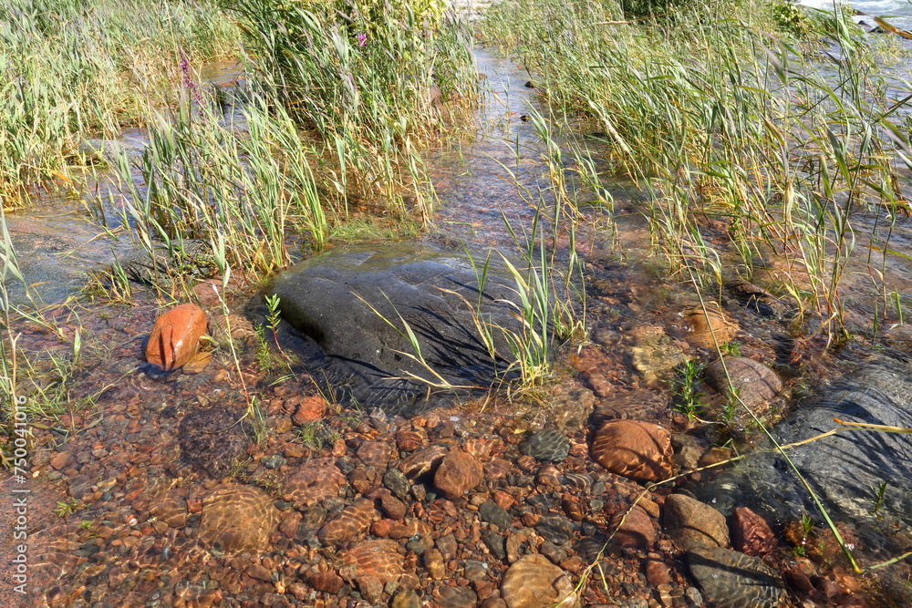 Small stones or boulders at a lake. Summer day. Vänern, Sweden 2023. Small stones or boulders at a lake. Summer day. Vänern, Sweden 2023.