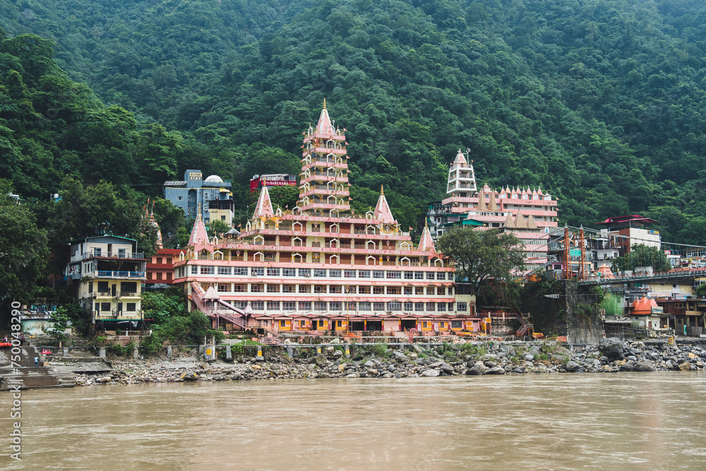 views of rishikesh city crossed by ganges river, india