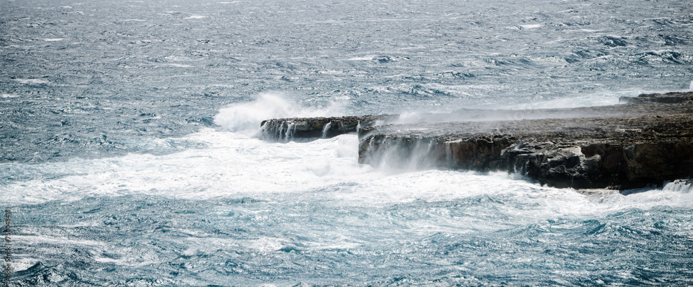 Banner with a seascape during a storm. Big waves in the ocean crash against the rocks